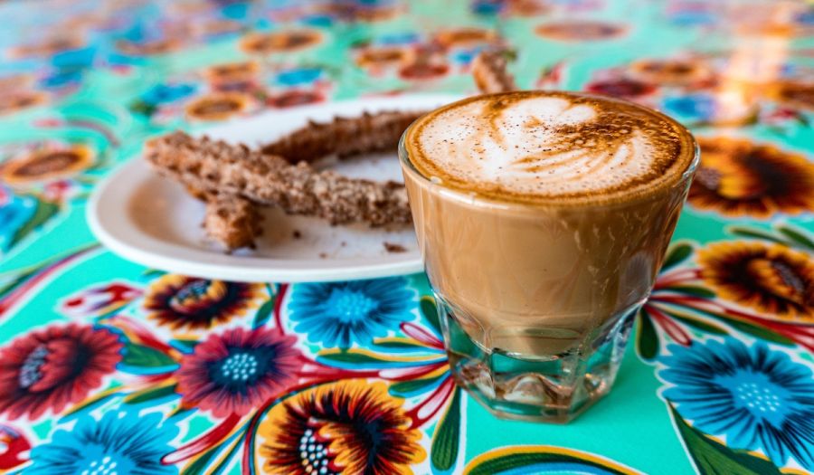 Coffee and fresh churros at Cocoa Cinnamon Lakewood in Durham, NC