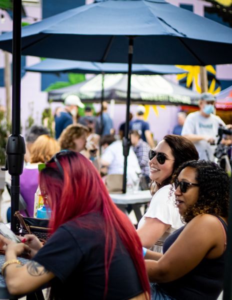 Patrons sit under umbrellas at the outdoor beer garden at The Glass Jug in RTP.