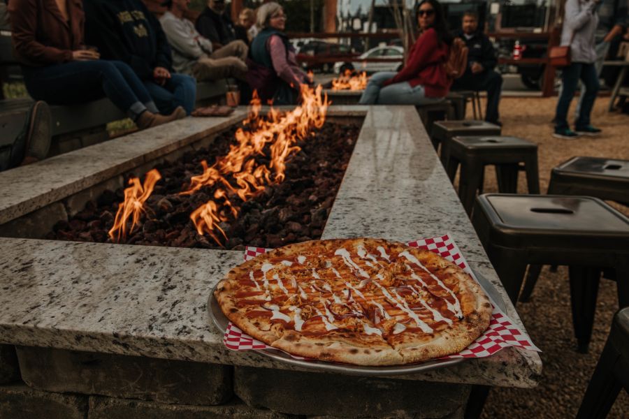 A delicious pizza warms by fireside at Boxcar Bar Arcade in Durham, NC.