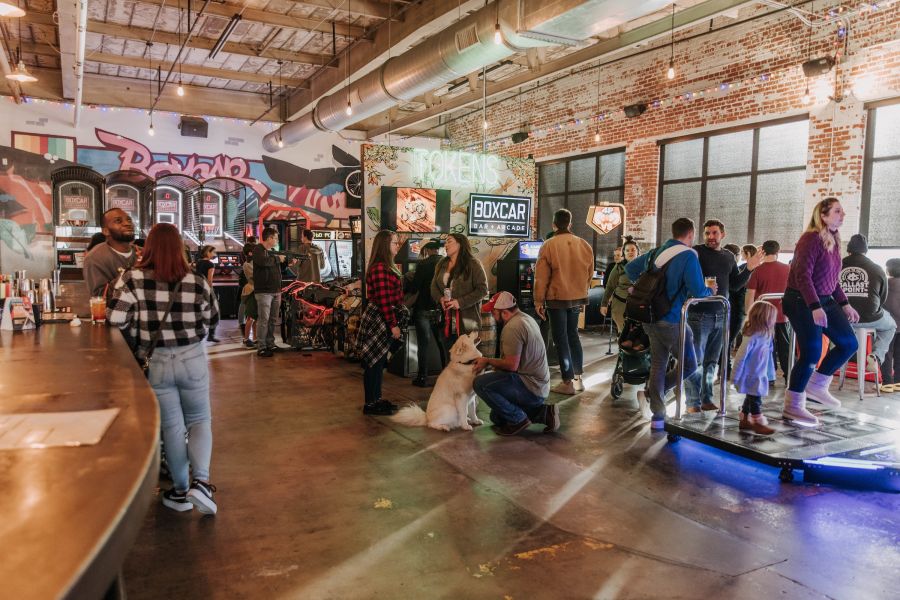 Bargoers enjoy the classic arcade games at Boxcar Bar + Arcade in downtown Durham.