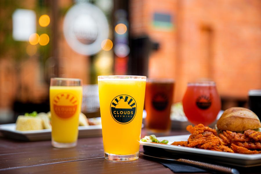 Draft beers and plates of food at Clouds Brewing in Durham, NC.