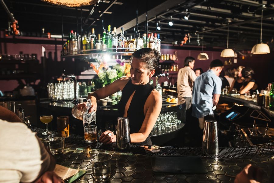 Owner Michelle Vanderwalker pours a cocktail behind the bar at Kingfisher.