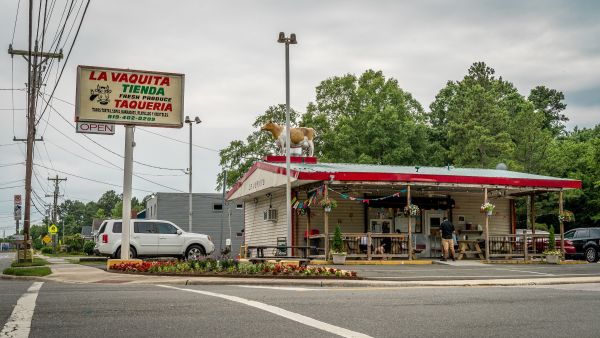 Clouds roll over the storefront of Taqueria La Vaquita in Durham, NC.