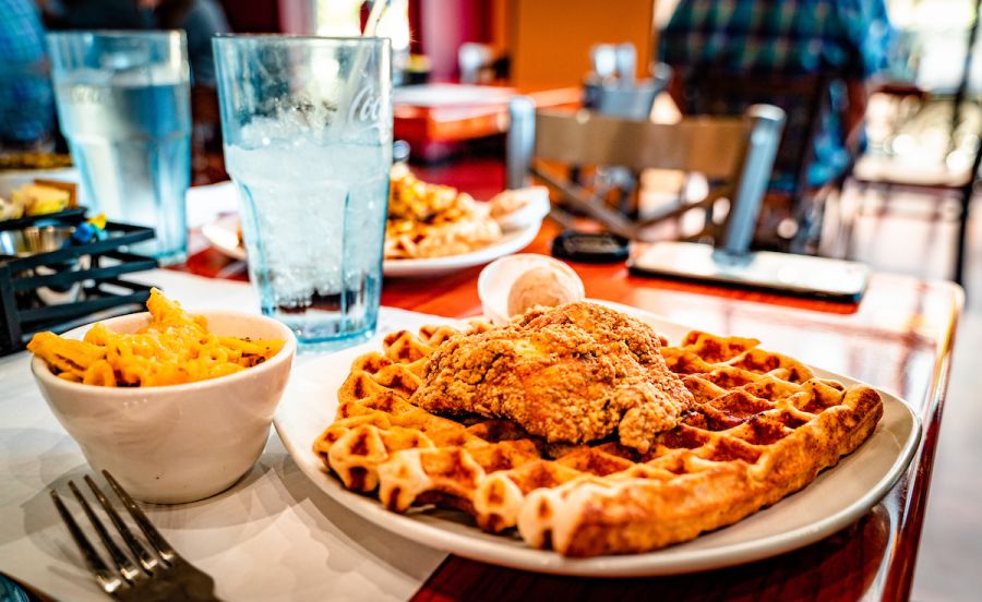 A hot plate of chicken and waffles fresh from the kitchen adorn a plate at Dame's Chicken and Waffles in Durham, NC.