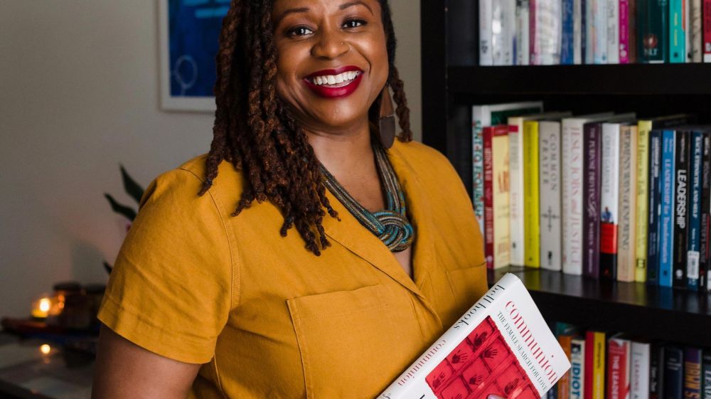 Dr. Margaret Brunson holds a copy of a Bell Hooks book in her office.