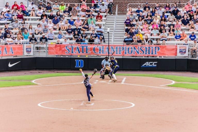 A pitcher throws a ball from the mound at a Duke softball game.