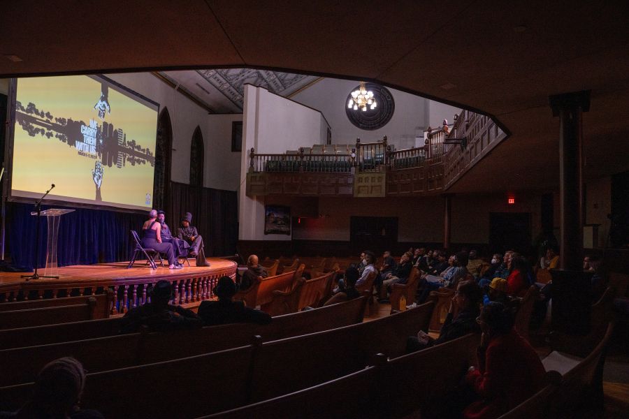 A panel sits on a stage and discusses a film at the Hayti Heritage Film Festival in Durham.