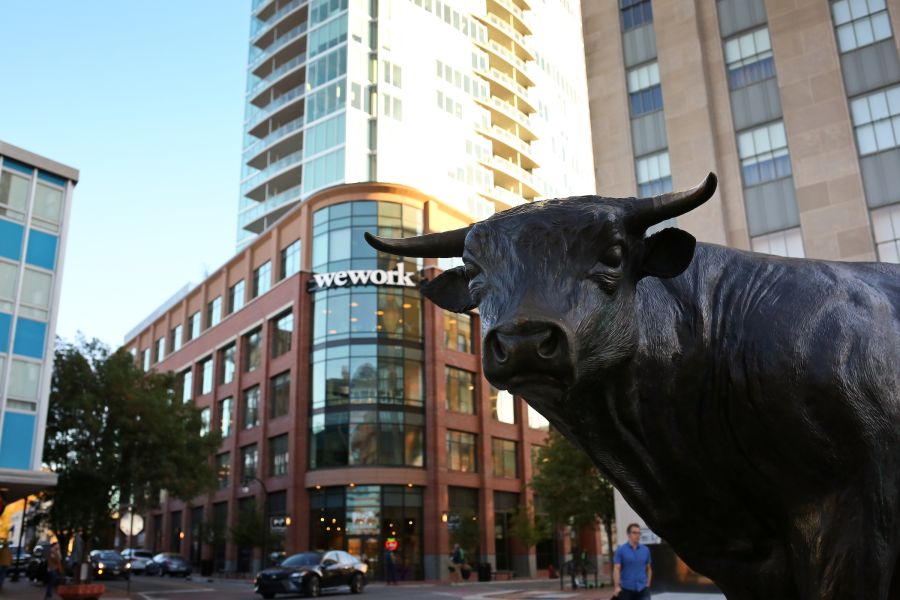 Major the Bull, the statue, stands in the middle of CCB Plaza under clear skies.