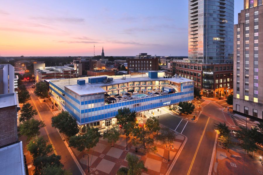 A sunburst sky sets over the Unscripted Hotel in Downtown Durham.