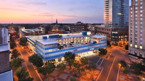 A sunburst sky sets over the Unscripted Hotel in Downtown Durham.