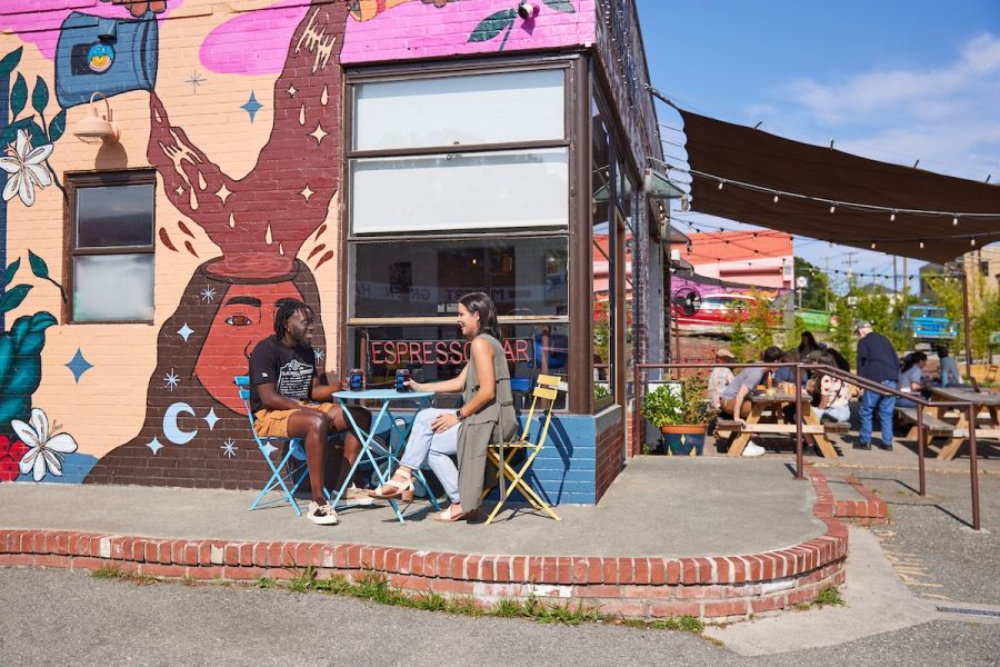 A couple enjoys coffee outside Cocoa Cinnamon on Geer Street in Durham, NC.