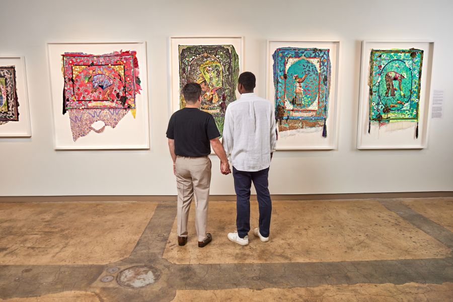 A couple admires artwork at the 21c Museum Hotel; a contemporary art museum, boutique hotel & restaurant + bar.