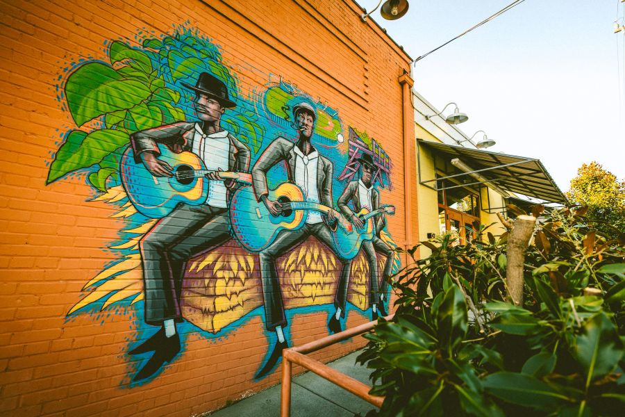 This mural outside of Blue Note Grill features Blind Boy Fuller, John Dee Holeman, and Reverend Gary Davis.