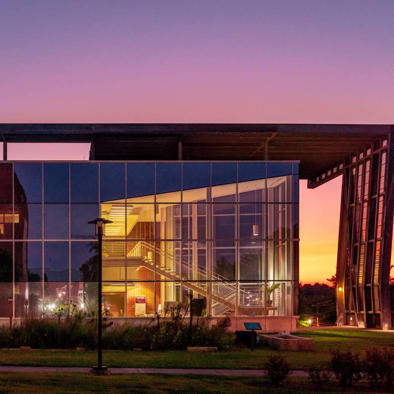 A pink sky sits behind the North Carolina Central University student center at sunset.