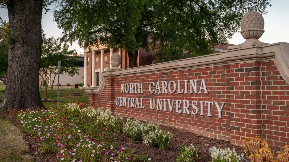 Plants surround the main sign on North Carolina Central University's campus.