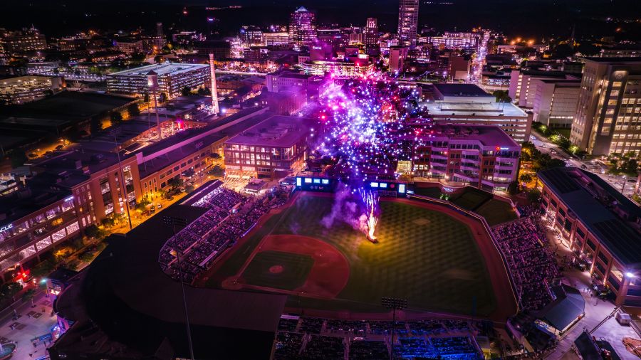 An aerial view displays a fireworks show at Durham Bulls Athletic Park.
