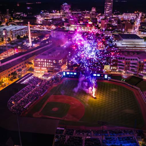 An aerial view displays a fireworks show at Durham Bulls Athletic Park.