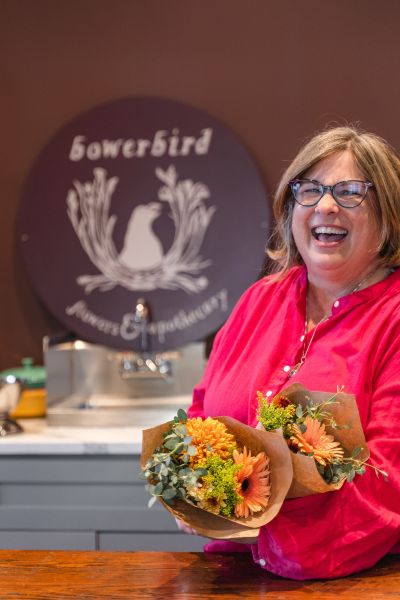 Diane Joyal poses with bouquets of flowers at her business, Bowerbird Flowers and Apothecary