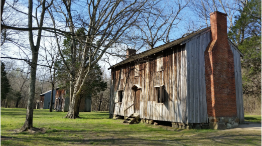 An old building sits alongside others at Historic Stagville in Durham