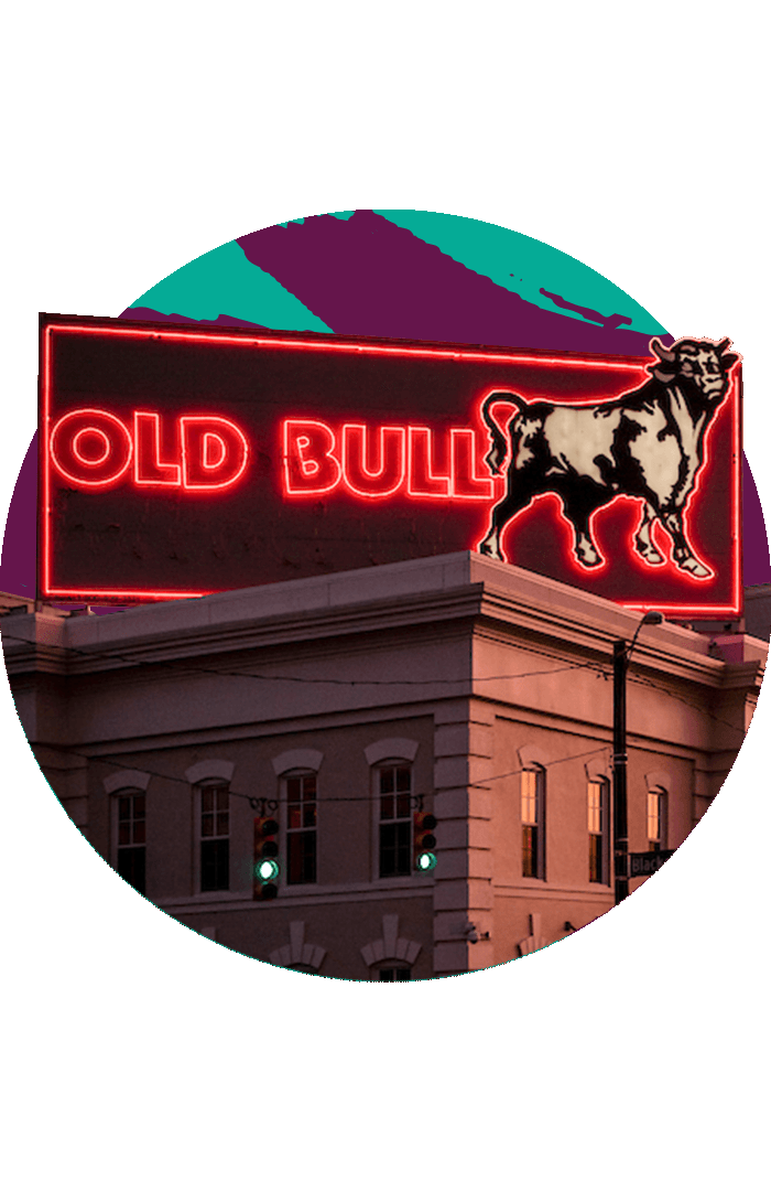 The neon Old Bull sign illuminated at sunset