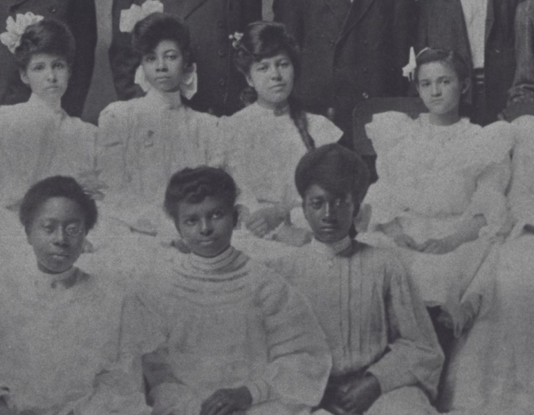 A black and white photo depicts students at the Whitted school.
