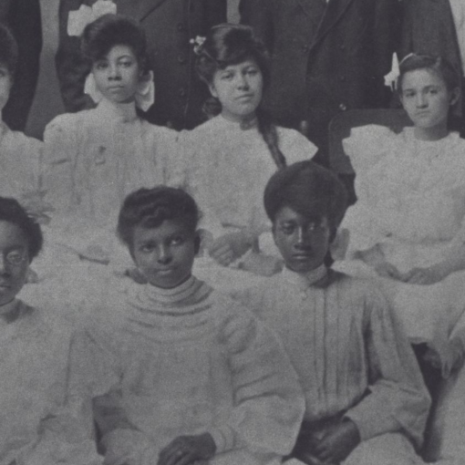 A black and white photo depicts students at the Whitted school.